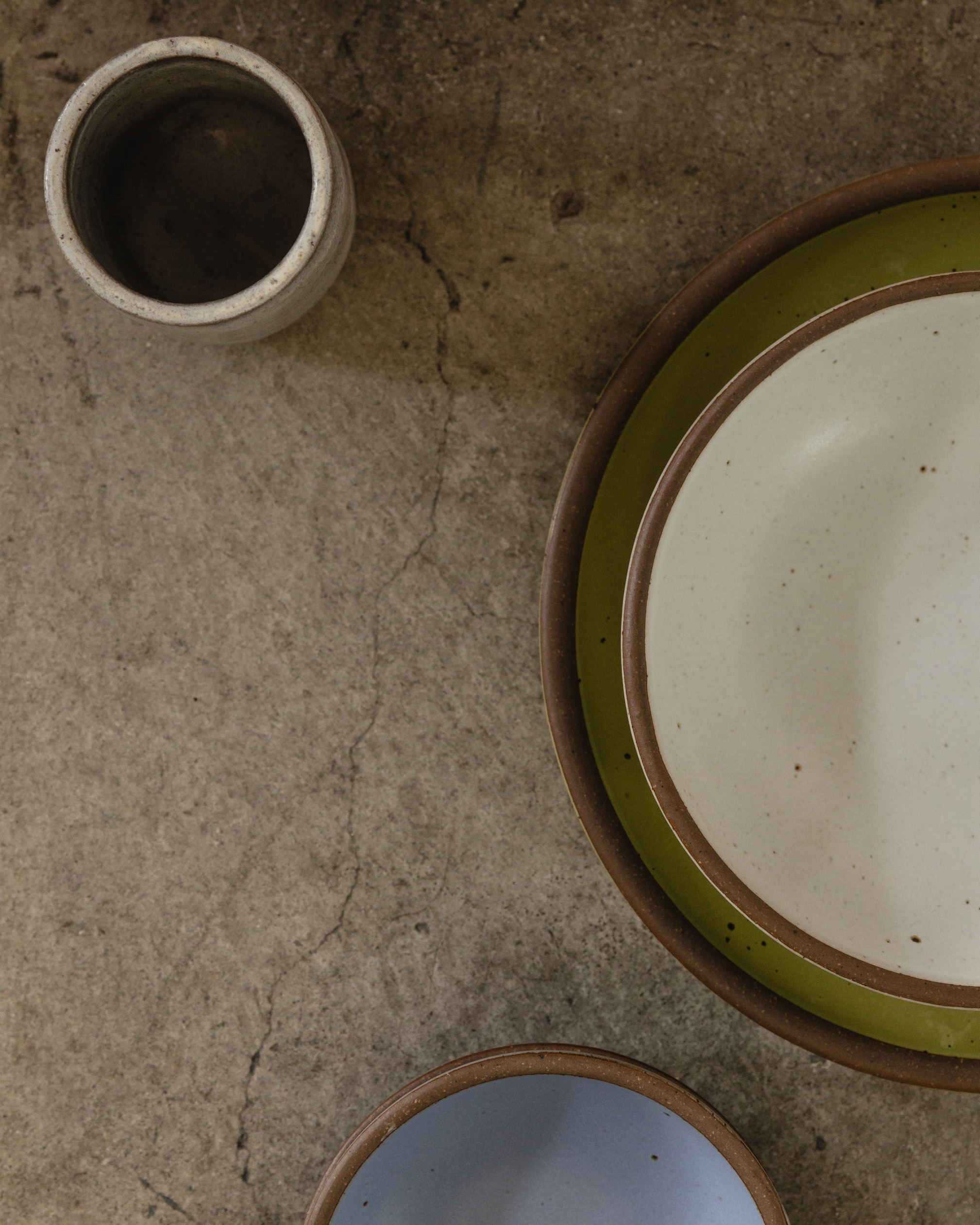 Two ceramic plates and a mug